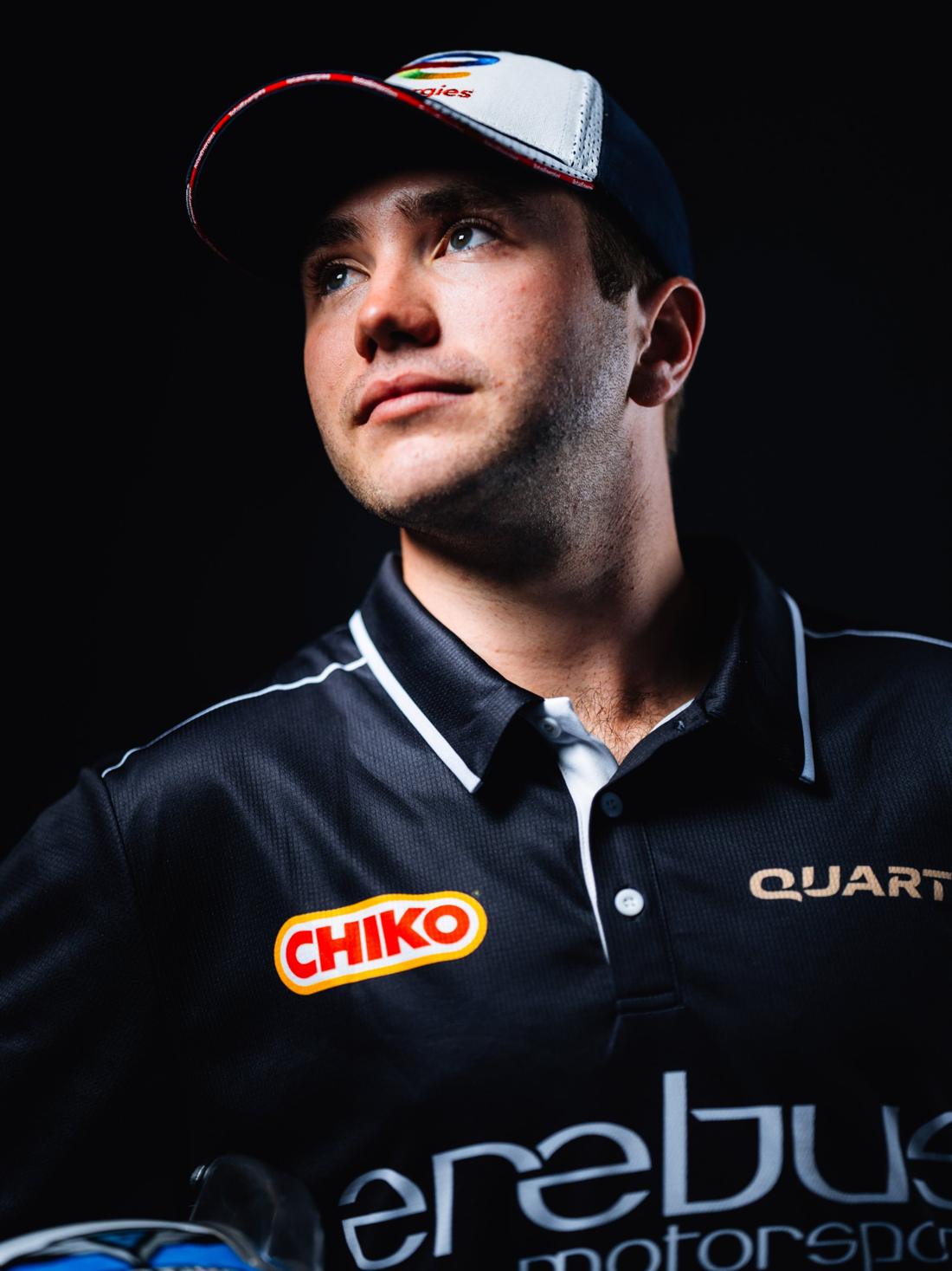 Portrait of Jarrod Hughes in a TotalEnergies cap and Erebus polo